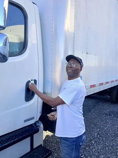 Commercial automotive locksmith assisting semi truck driver with lock and key service in Melbourne FL