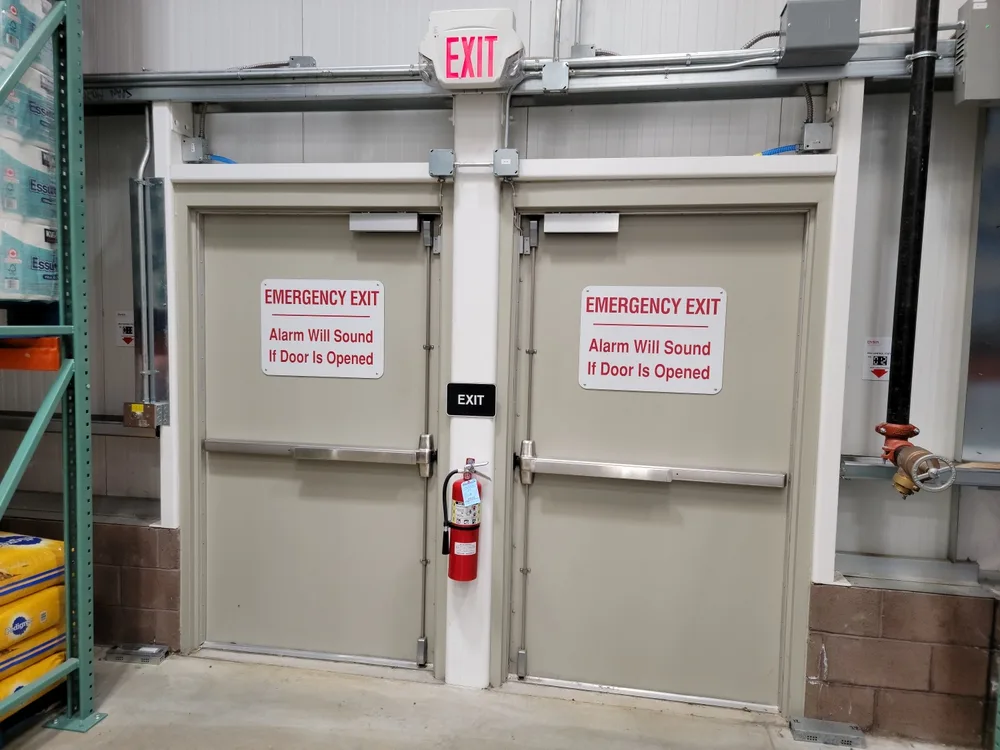 Commercial locksmith services in Melbourne Florida installing and securing emergency exit door push bars with access control solutions