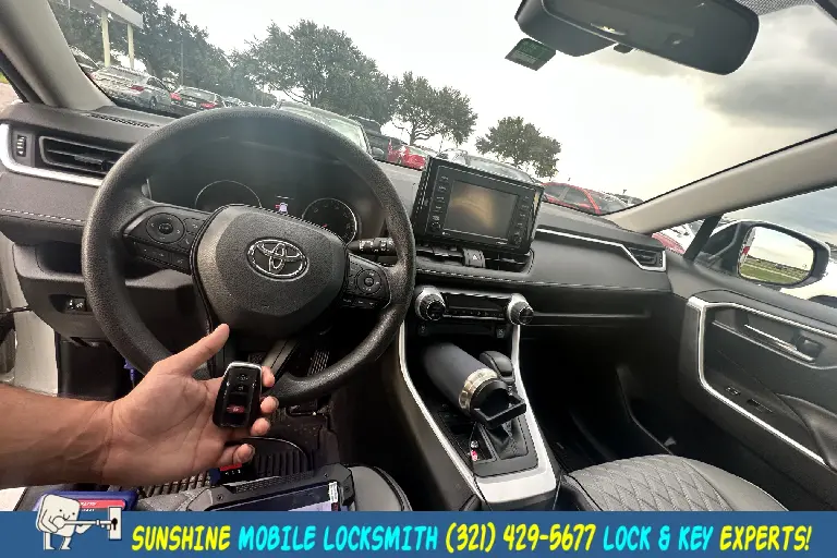 Car locksmith in Melbourne FL assisting with Toyota key fob replacement, ignition repair, and 24/7 emergency lockout service.