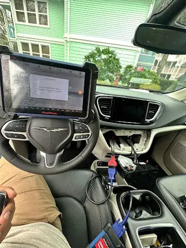 Locksmith in Palm Bay FL performing key fob programming and replacement with diagnostic tools for modern push-to-start vehicles.
